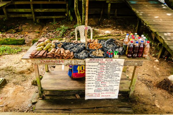 Colorful booth displaying local Amazonian snacks, drinks, and traditional goods in Puerto Nariño, Amazonas, Colombia.