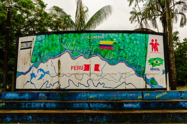 Colorful mural detailing the borders of Colombia, Peru, and Brazil at Parque Santander in Leticia, Amazonas, showcasing vibrant local art.