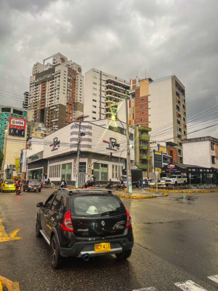 Bucaramanga streets under cloudy skies showcase modern buildings and bustling traffic, capturing the urban energy of Santander, Colombia.