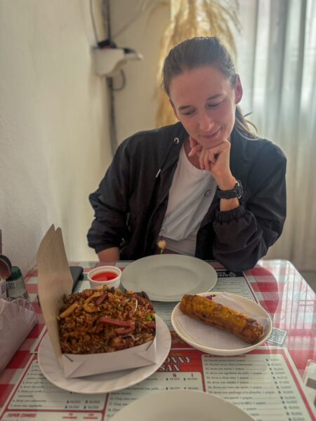 Enjoying a traditional meal in Bucaramanga, Colombia, featuring a colorful dish and an appetizing tamale on the table.