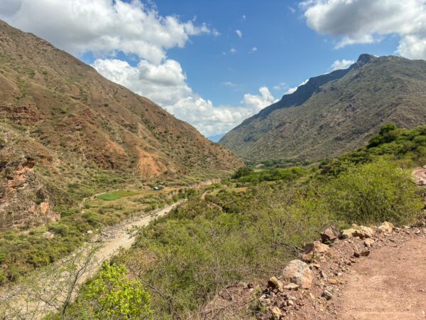 Stunning vista of Chicamocha Canyon in Santander, Colombia, showcasing rugged mountains, green valleys, and a bright blue sky.