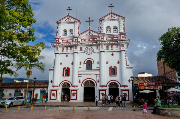 Parroquia Nuestra Señora del Carmen in Guatapé, with its red-and-white striped façade facing the main square
