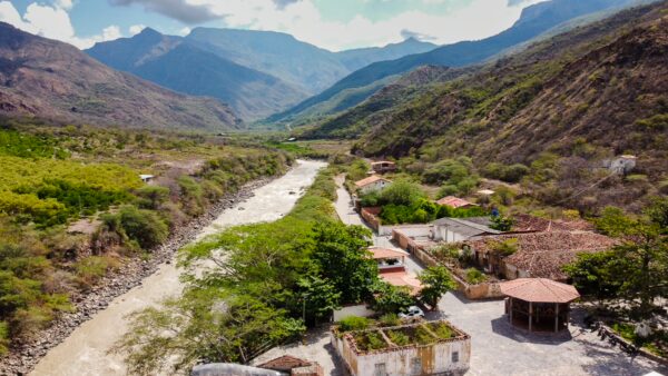Aerial view of Jordán in Chicamocha Canyon with the river, scattered houses, and steep dry hillsides