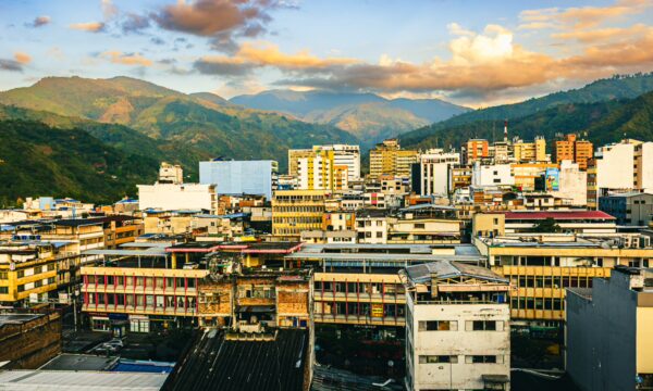 Vibrant city skyline showcasing various buildings with a backdrop of lush hills in Ibagué, Tolima, Colombia.