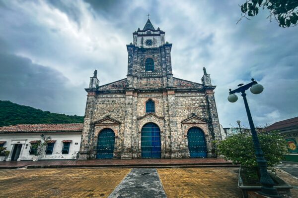 Nuestra Señora de Rosario church stands majestically in Honda, Tolima, Colombia, framed by dramatic cloudy skies.