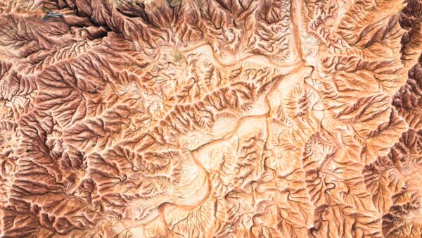 Intricate patterns of reddish-brown rock formations create a labyrinthine landscape in the Tatacoa Desert, Huila, Colombia.