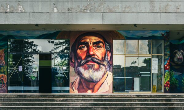 Vibrant mural of an older man with a beard adorns the facade of a building in Santa Rosa de Cabal, Risaralda, Colombia.