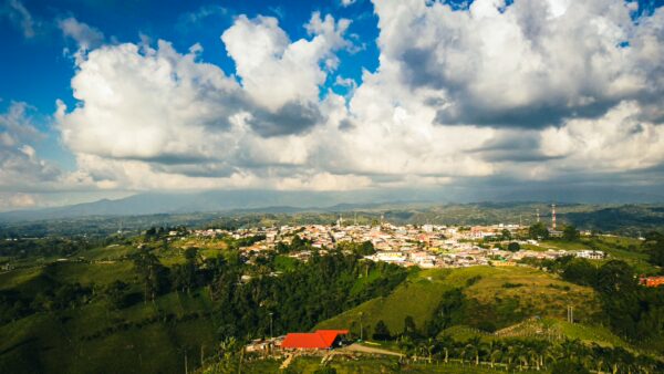 Stunning view from Mirador Colina Iluminada, showcasing lush greenery and a vibrant sky over Filandia, Quindío, Colombia.