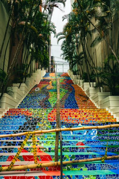 Colorful mosaic staircase leading up through lush greenery at Parque Centenario, Ibagué, Tolima, Colombia.