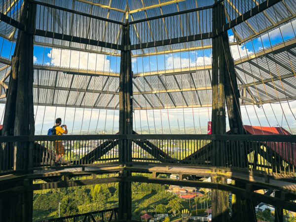 Panoramic views from the wooden structure at Mirador Colina Iluminada, showcasing lush greenery in Filandia, Quindío, Colombia.