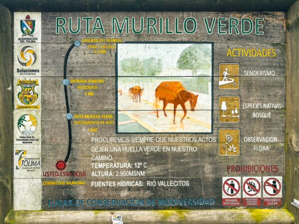 Murillo Verde route sign in Tolima, Colombia, featuring information on activities, temperature, and local wildlife.