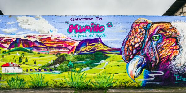 Vivid mural featuring a colorful eagle and landscapes, welcoming visitors to Murillo in Tolima, Colombia.