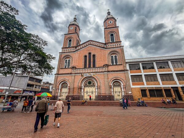 San Francisco de Asís Church stands prominently in Armenia, Quindío, showcasing its intricate architecture against a moody sky.