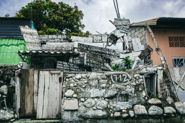 Rustic stone walls and wooden doors display unique artistic elements in a quaint neighborhood of Honda, Tolima, Colombia.