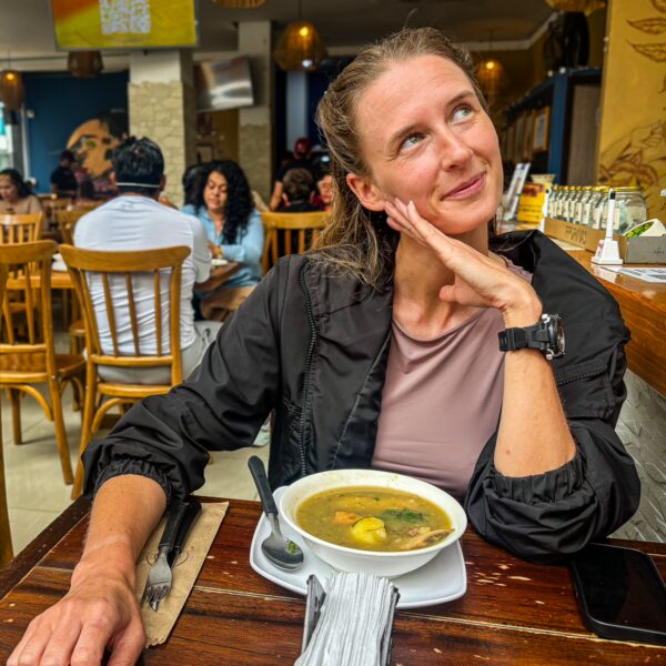 Warm, inviting interior of Jardin Montanero restaurant in Armenia, Quindío, Colombia, with a guest enjoying a bowl of soup.