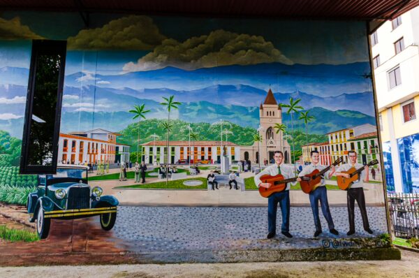 Vibrant mural depicting musicians and a vintage car, capturing the essence of Parque de la Vida in Armenia, Quindío, Colombia.