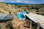 Turquoise pool nestled among the rugged, sandy formations of Los Hoyos in Tatacoa Desert, Huila, Colombia.