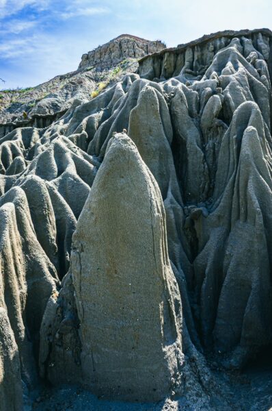 Stunning rock formations rise sharply in the Los Hoyos area of Tatacoa Desert, Huila, Colombia, showcasing unique textures and colors.