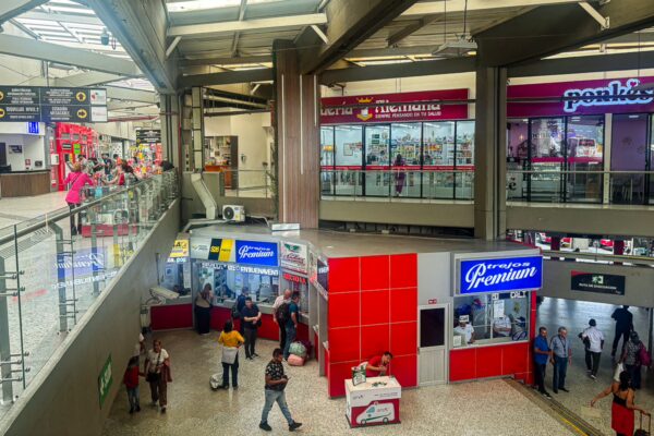 Modern bus terminal featuring shops and waiting areas, bustling with travelers in Armenia, Quindio, Colombia.