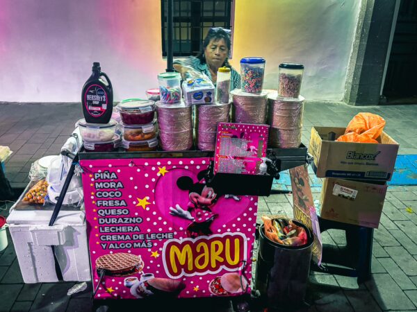 Colorful street cart named Maru in Parque Caldas, Popayán, Cauca, Colombia, displaying various treats like ice cream and snacks.