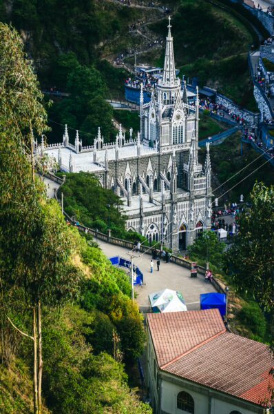 Stunning view of Las Lajas Sanctuary surrounded by lush greenery in Nariño, Colombia, showcasing its intricate architecture.