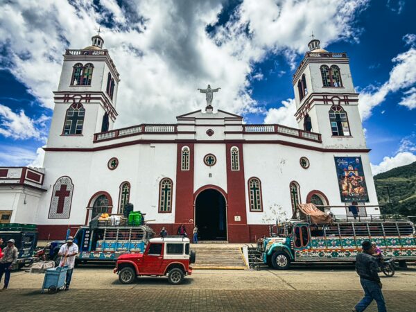 Nuestra Señora del Perpetuo Socorro features striking red and white architecture against a vibrant sky in Silva, Cauca, Colombia.