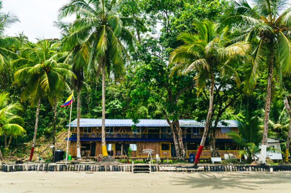 Chucheros Beach features a vibrant wooden structure surrounded by lush palm trees in Uramba, Bahía Málaga, Valle del Cauca, Colombia.