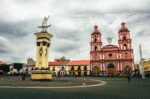 Historic 20 de Julio Park features a grand monument and the striking pink twin churches in Ipiales, Nariño, Colombia.