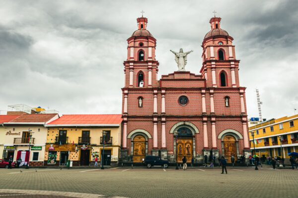 Catedral de San Pedro Mártir showcases striking pink architecture with twin towers and a central statue in Ipiales, Nariño, Colombia.