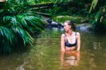 Relaxing in serene waters surrounded by lush green vegetation in Tres Marias, Uramba, Bahia Malaga, Valle del Cauca, Colombia.