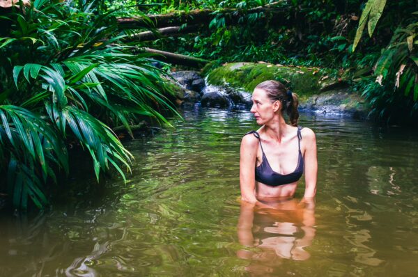 Relaxing in serene waters surrounded by lush green vegetation in Tres Marias, Uramba, Bahia Malaga, Valle del Cauca, Colombia.