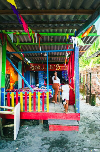 Colorful restaurant with vibrant decorations and local atmosphere in Juanchaco, Valle del Cauca, Colombia, near the beach.