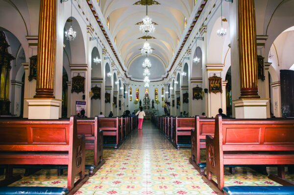 Catedral San Pedro features an elegant interior with arches, wooden pews, and colorful tile flooring in Cali, Valle del Cauca, Colombia.