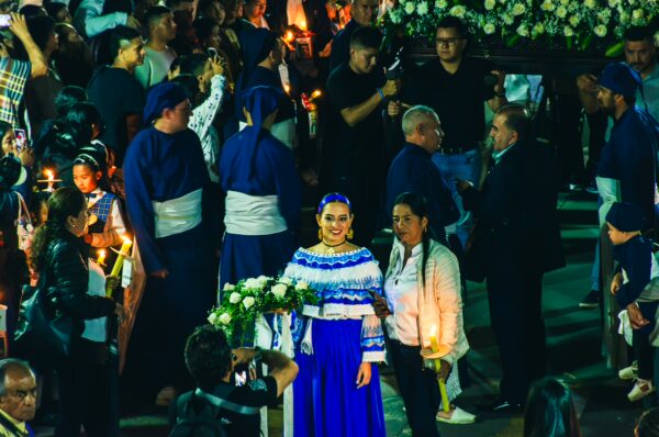 Vibrant celebration in Popayán, Colombia, featuring people in traditional attire and floral decorations during a festive event.