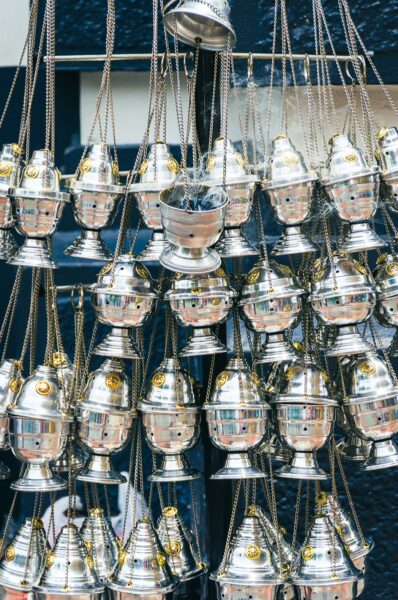 Silver incense burners hang in intricate layered arrangements, showcasing craftsmanship near Catedral San Pedro, Cali, Valle del Cauca, Colombia.