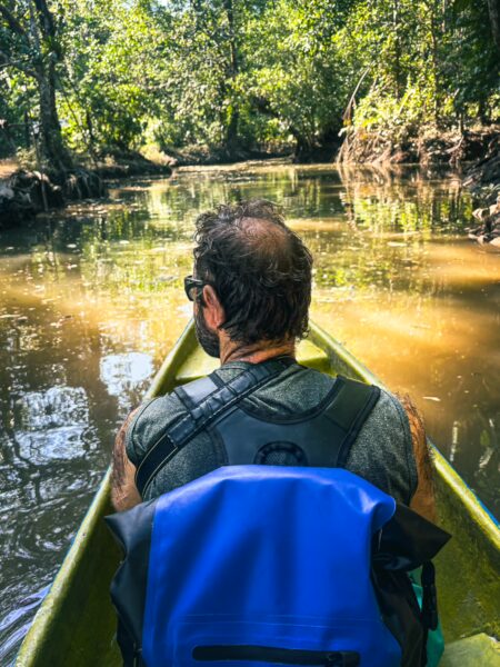 Canoeing through lush greenery along the calm waters of the natural pool in Ladrilleros, Valle del Cauca, Colombia.