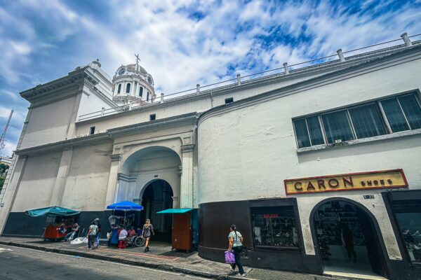 Catedral San Pedro features a grand white facade and a towering dome, set against a vibrant blue sky in Cali, Valle del Cauca.