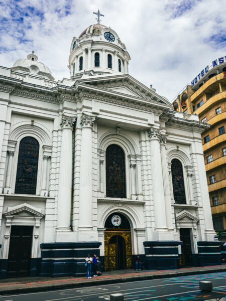 Elegant white façade of Catedral San Pedro in Cali, Valle del Cauca, features intricate detailing and large arched windows.