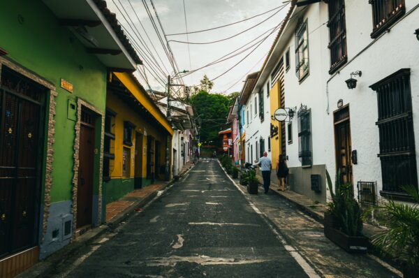 Charming San Antonio street in Cali, Valle del Cauca, Colombia, featuring colorful houses and lush greenery.
