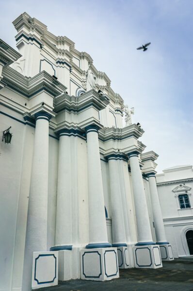 Assumption Cathedral features white columns with blue accents against a clear sky in Popayán, Cauca, Colombia.