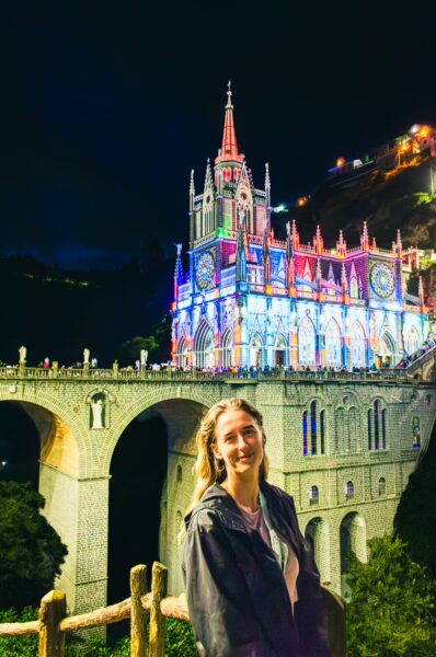 Las Lajas Sanctuary illuminated at night, showcasing its stunning architecture and vibrant colors in Nariño, Colombia.