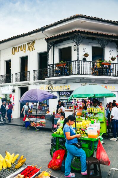 Colorful market stalls filled with fresh fruits and vegetables outside the Aarray building in Popayán, Cauca, Colombia.