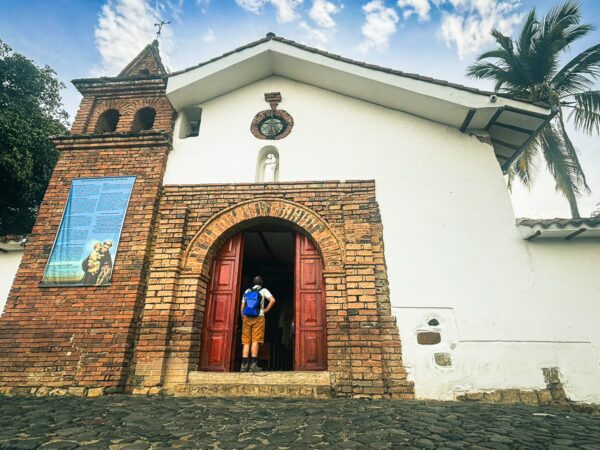 Colina de San Antonio features a charming white church with red doors, set against a bright sky in Cali, Valle del Cauca, Colombia.