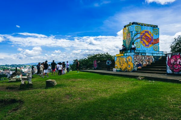 Colorful graffiti adorns the viewing platform at Morro de Tulcán, offering stunning views over Popayán, Cauca, Colombia.