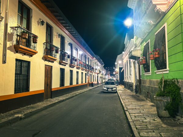 Charming streets of San Marcos in Quito, Ecuador, lined with traditional colonial buildings and warm evening lighting.