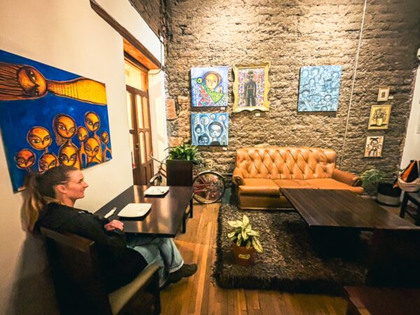 Vibrant artwork on the walls complements the cozy seating area at Bocanada Pizza Restaurant in Quito, Ecuador.