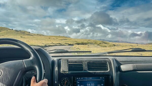 Rugged terrain and dramatic skies seen from a vehicle in Cotopaxi National Park, Ecuador, showcasing natural beauty and adventure.