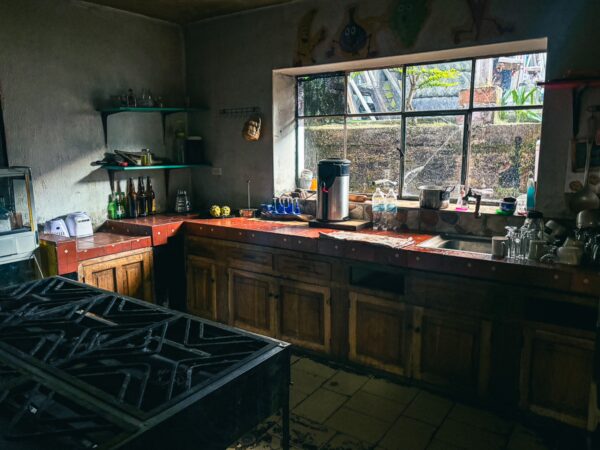 Rustic kitchen interior at Refugio Terra Esperanza in La Esperanza, Ibarra, Ecuador, featuring a large gas stove and natural light.