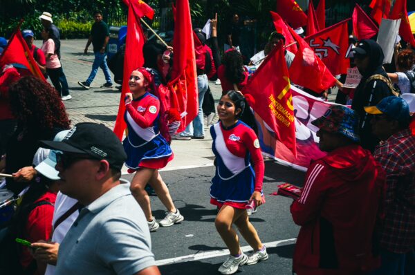 Colorful flags wave in the air as participants march in the International Workers' Day parade in Quito, Ecuador.