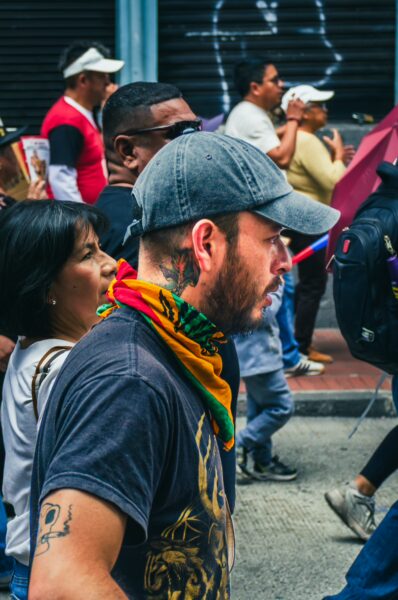 Participants in the International Workers' Day parade wear colorful attire, showcasing unity in the streets of Quito, Ecuador.